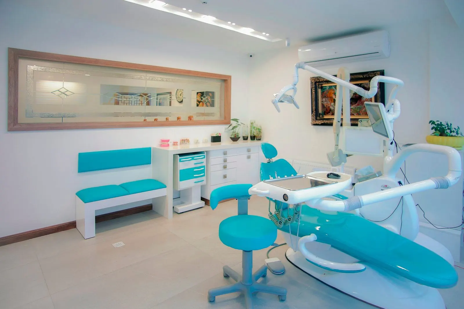 Consultorio dental con su sillón turquesa y sala de espera